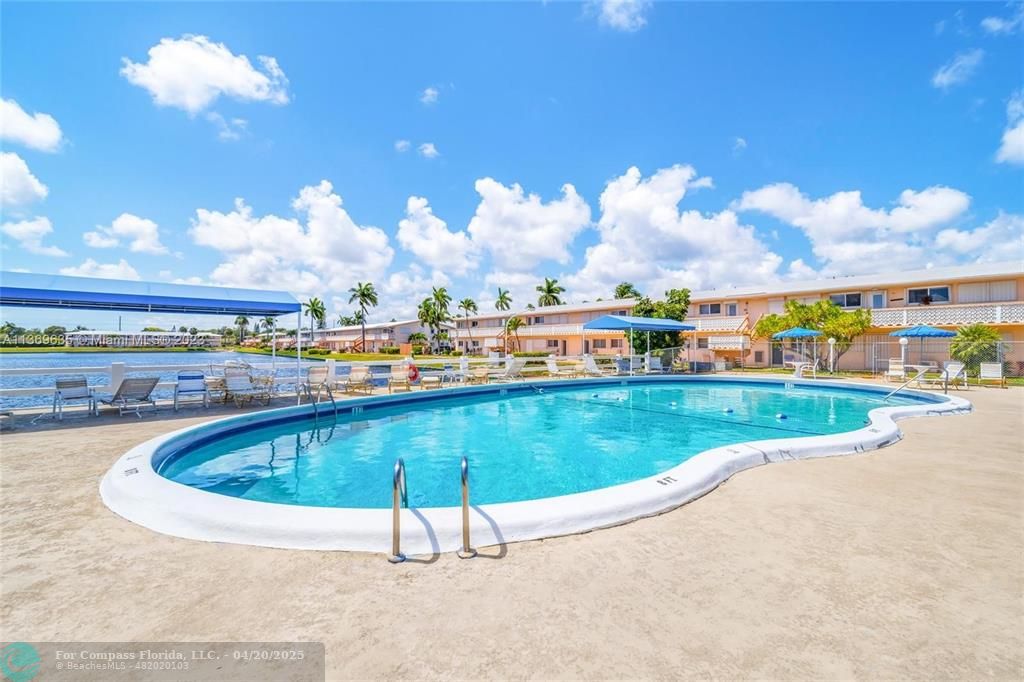 725 Southwest 11th Avenue, Unit 6F Hallandale Beach, FL 33009 - Photo 10 of 12 a view of swimming pool outdoor outdoor seating and city view