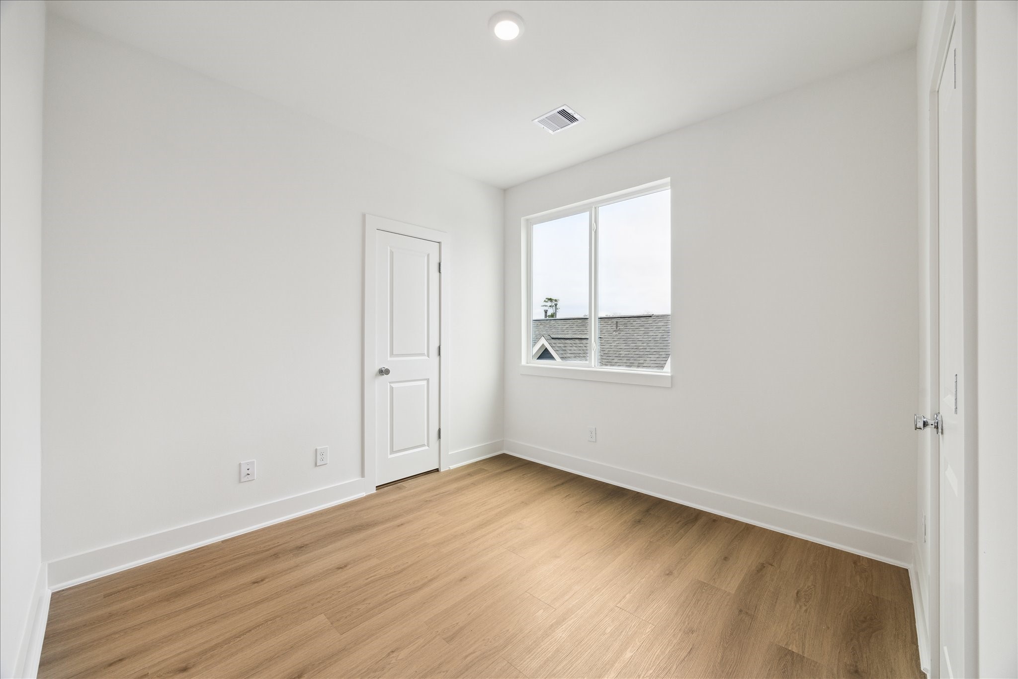 1650 West Tidwell Road Houston, TX 77091 - Photo 11 of 18 an empty room with wooden floor and windows