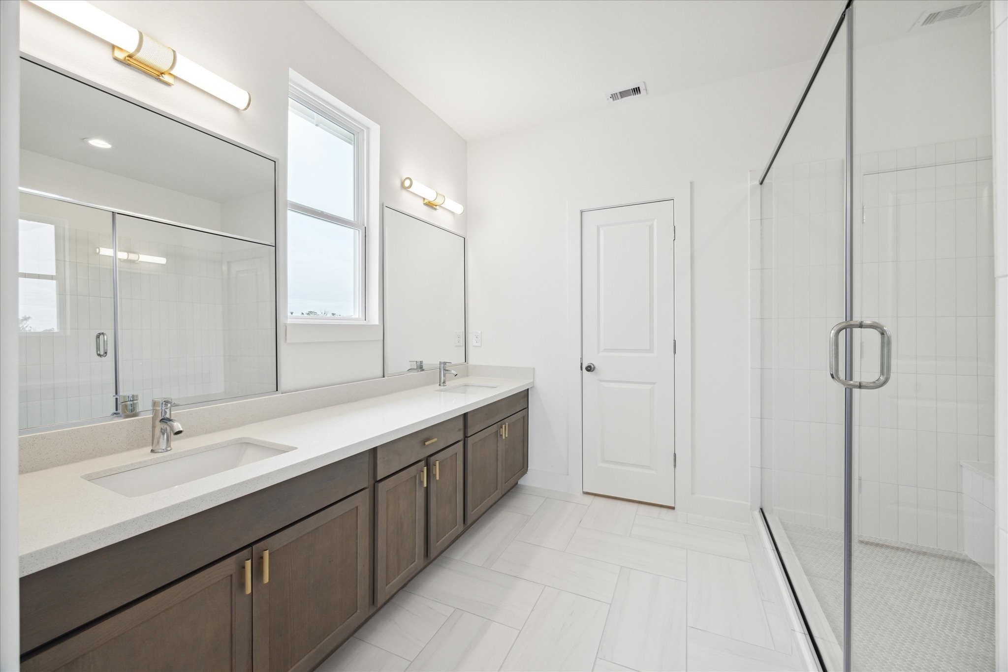 1650 West Tidwell Road Houston, TX 77091 - Photo 6 of 18 a bathroom with a double vanity sink and mirror