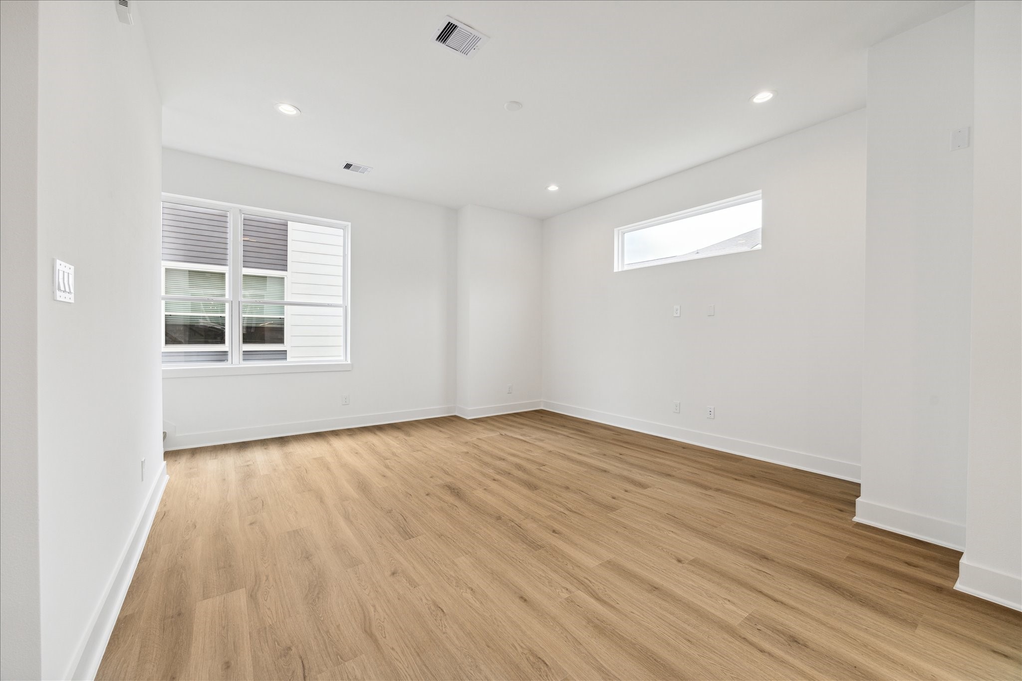 1650 West Tidwell Road Houston, TX 77091 - Photo 8 of 18 an empty room with wooden floor and windows