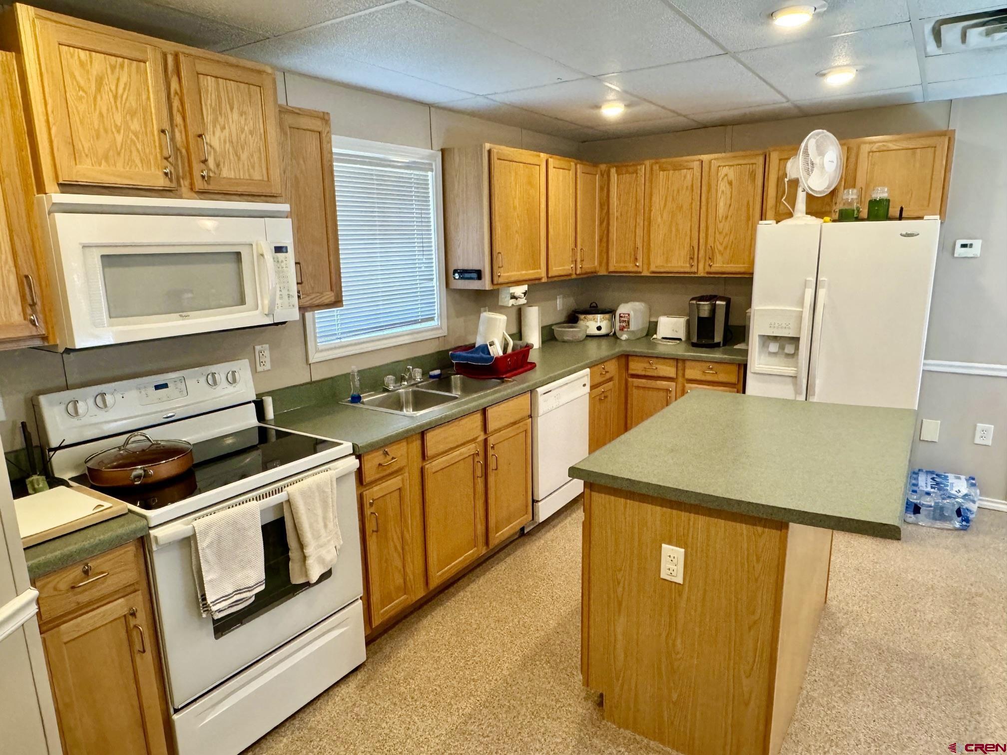 100 Sawmill Road, Unit REGINA MOUNTAIN RANCH Counselor, NM 87018 - Photo 16 of 32 a kitchen with stainless steel appliances granite countertop a stove a sink dishwasher and a refrigerator