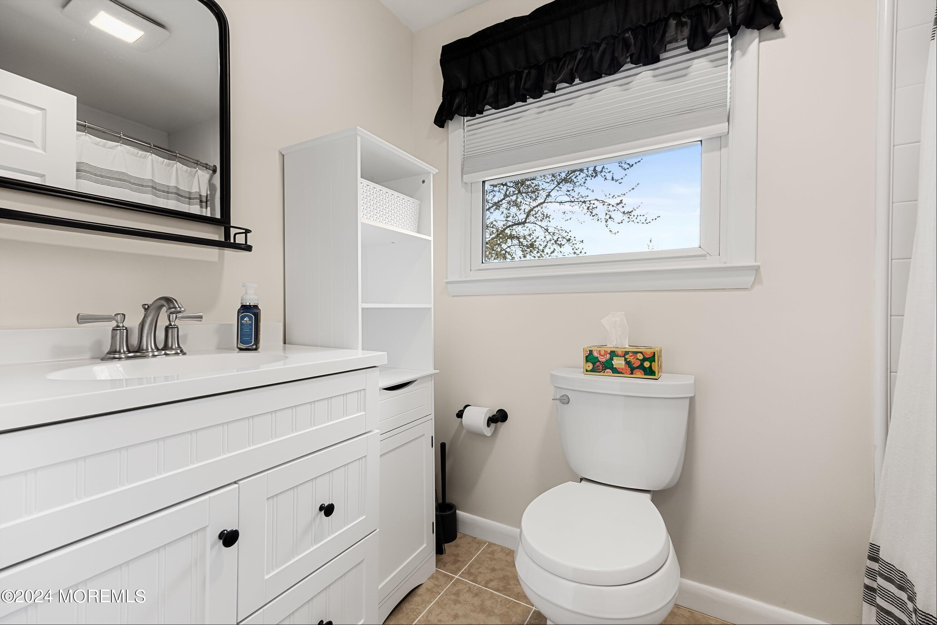 325 Ithaca Avenue Delran, NJ 08075 - Photo 15 of 19 a bathroom with a toilet a sink and a mirror