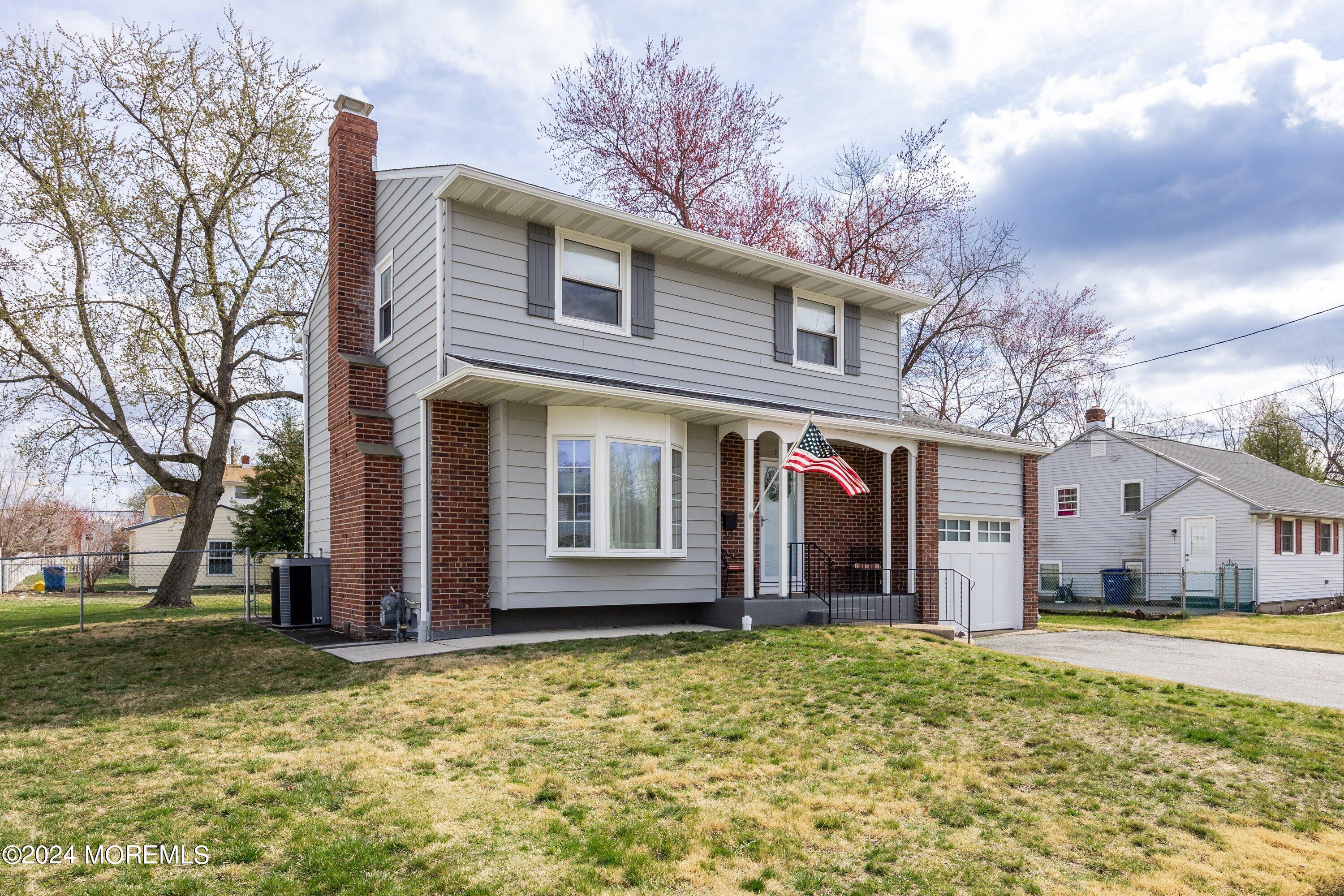 325 Ithaca Avenue Delran, NJ 08075 - Photo 2 of 19 a view of a white house with a large tree and wooden fence