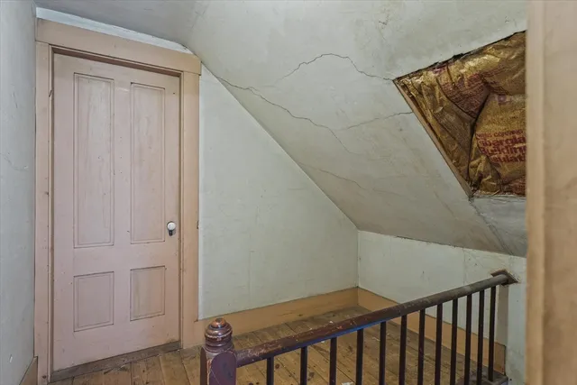 a view of a hallway with wooden floor and entryway