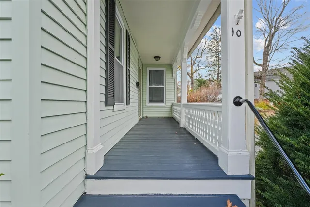 a view of a yard with large trees and wooden fence