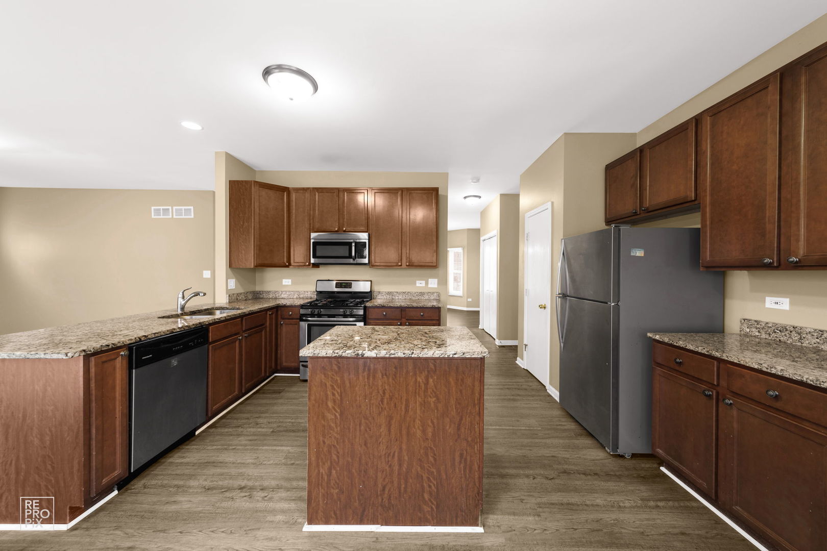 5519 Feather Creek Road Matteson, IL 60443 - Photo 12 of 26 a large kitchen with stainless steel appliances granite countertop a stove refrigerator and a sink