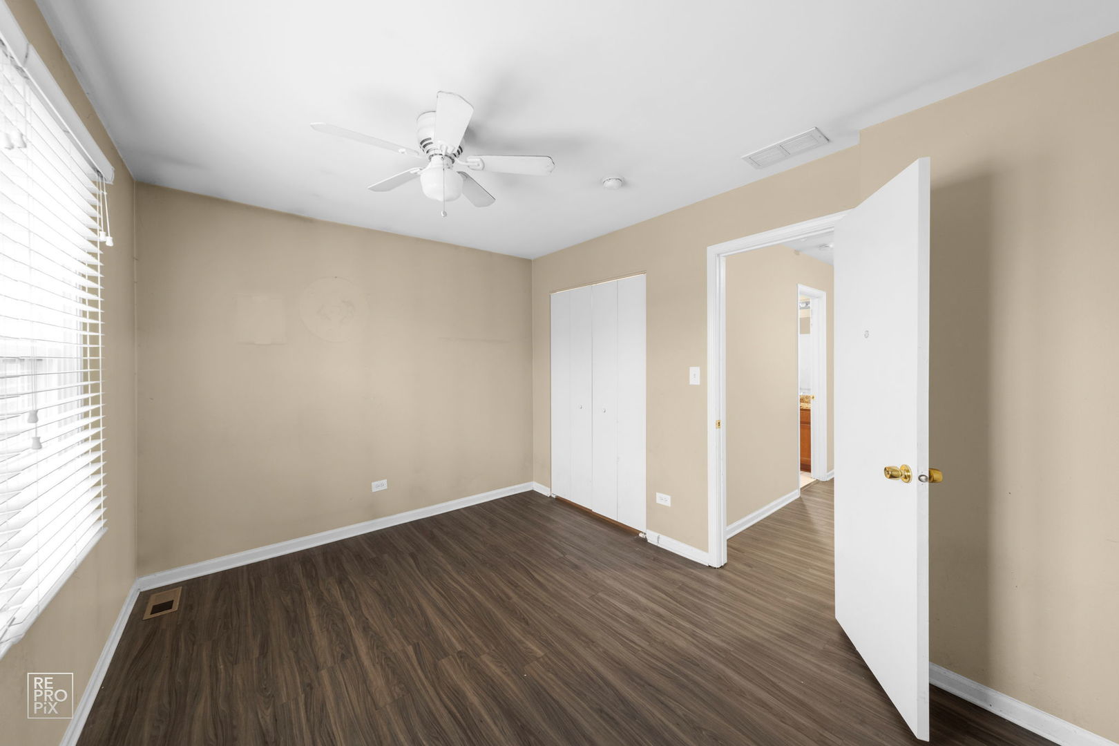 5519 Feather Creek Road Matteson, IL 60443 - Photo 21 of 26 an empty room with wooden floor and windows