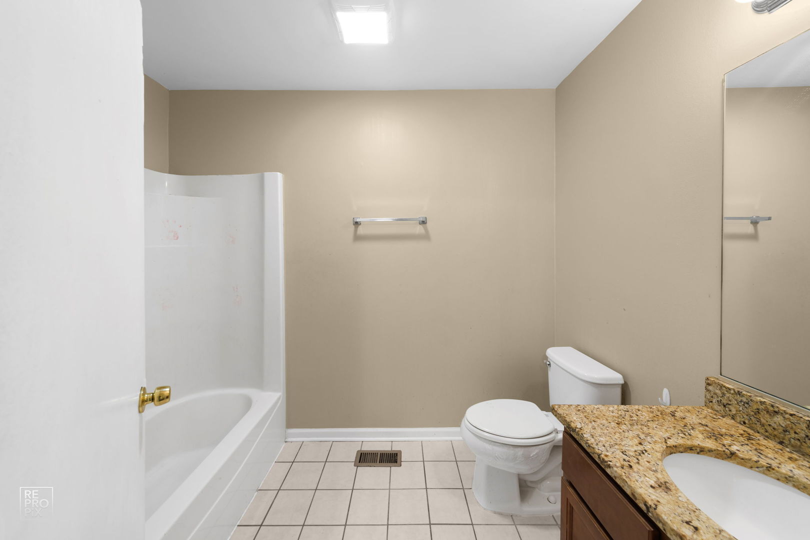 5519 Feather Creek Road Matteson, IL 60443 - Photo 22 of 26 a bathroom with a granite countertop sink a toilet and bathtub