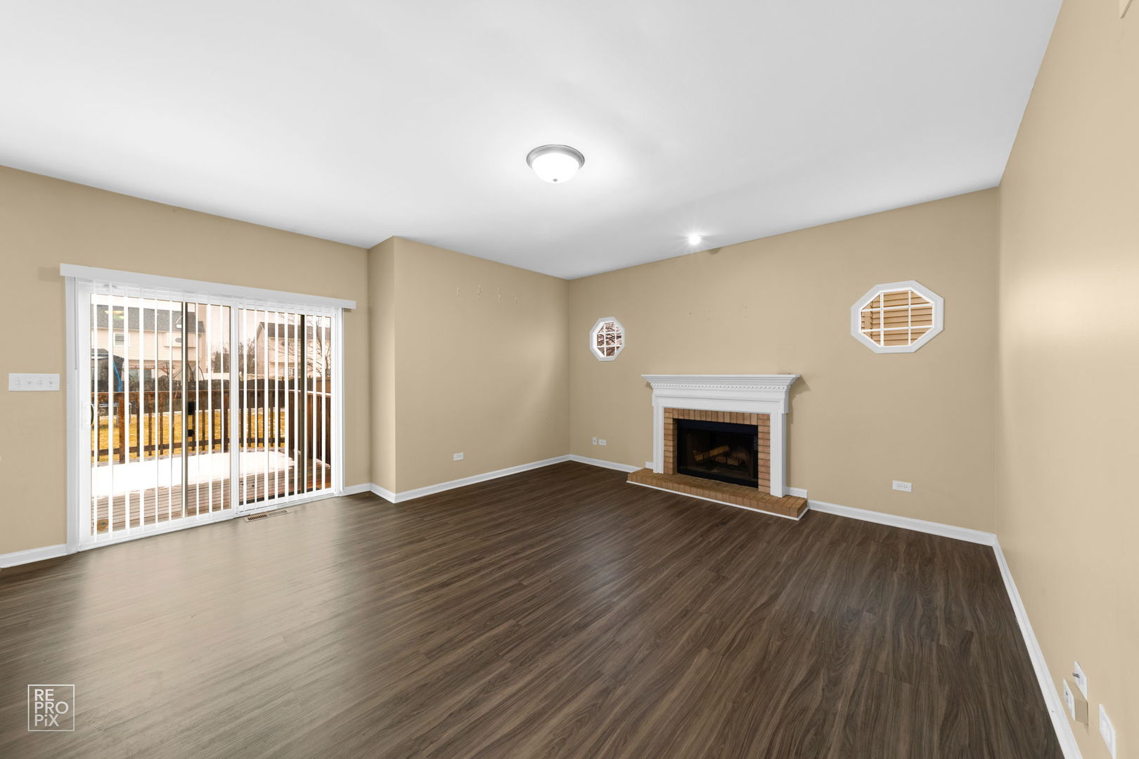 5519 Feather Creek Road Matteson, IL 60443 - Photo 9 of 26 a view of an empty room with glass door and wooden floor