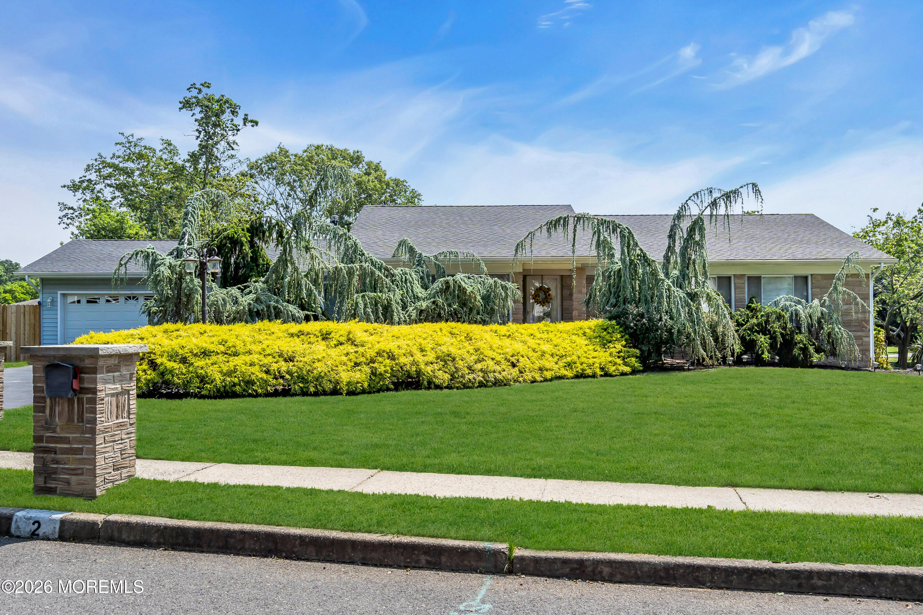a view of a house with a big yard and potted plants