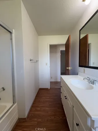 a spacious bathroom with a double vanity sink and a mirror