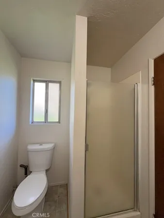 a white toilet sitting next to a bathroom sink