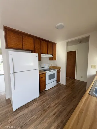 a kitchen with a refrigerator a stove top oven a sink and dishwasher