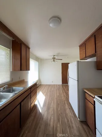 a kitchen with a refrigerator and a sink