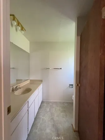 a bathroom with a granite countertop sink and mirror