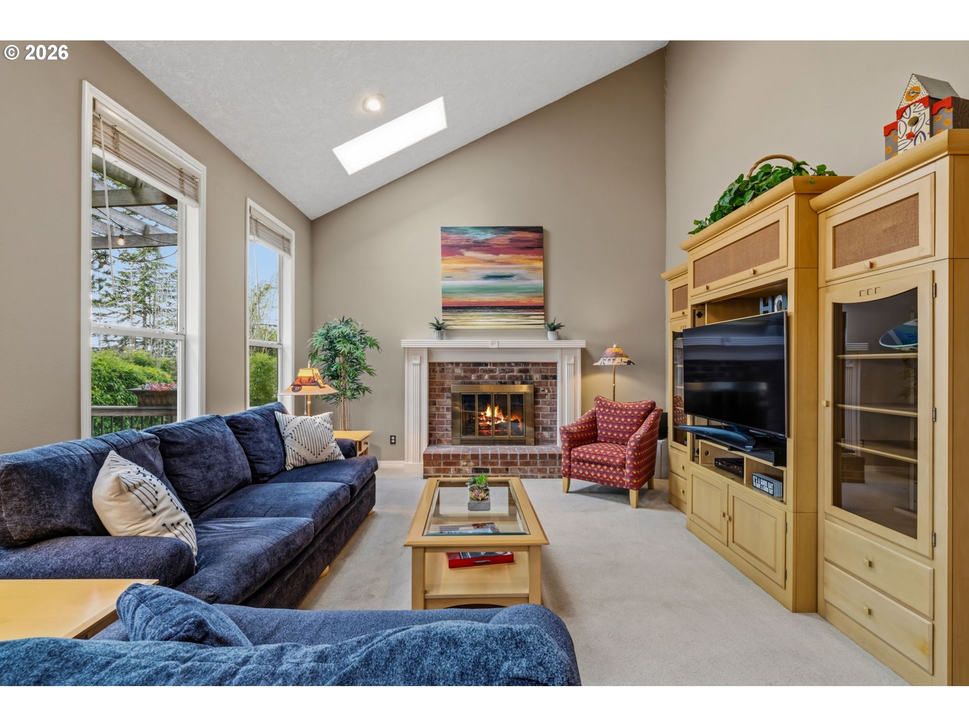 6108 Southwest Kruse Ridge Drive Portland, OR 97219 - Photo 14 of 42 a living room with furniture a flat screen tv and a fireplace
