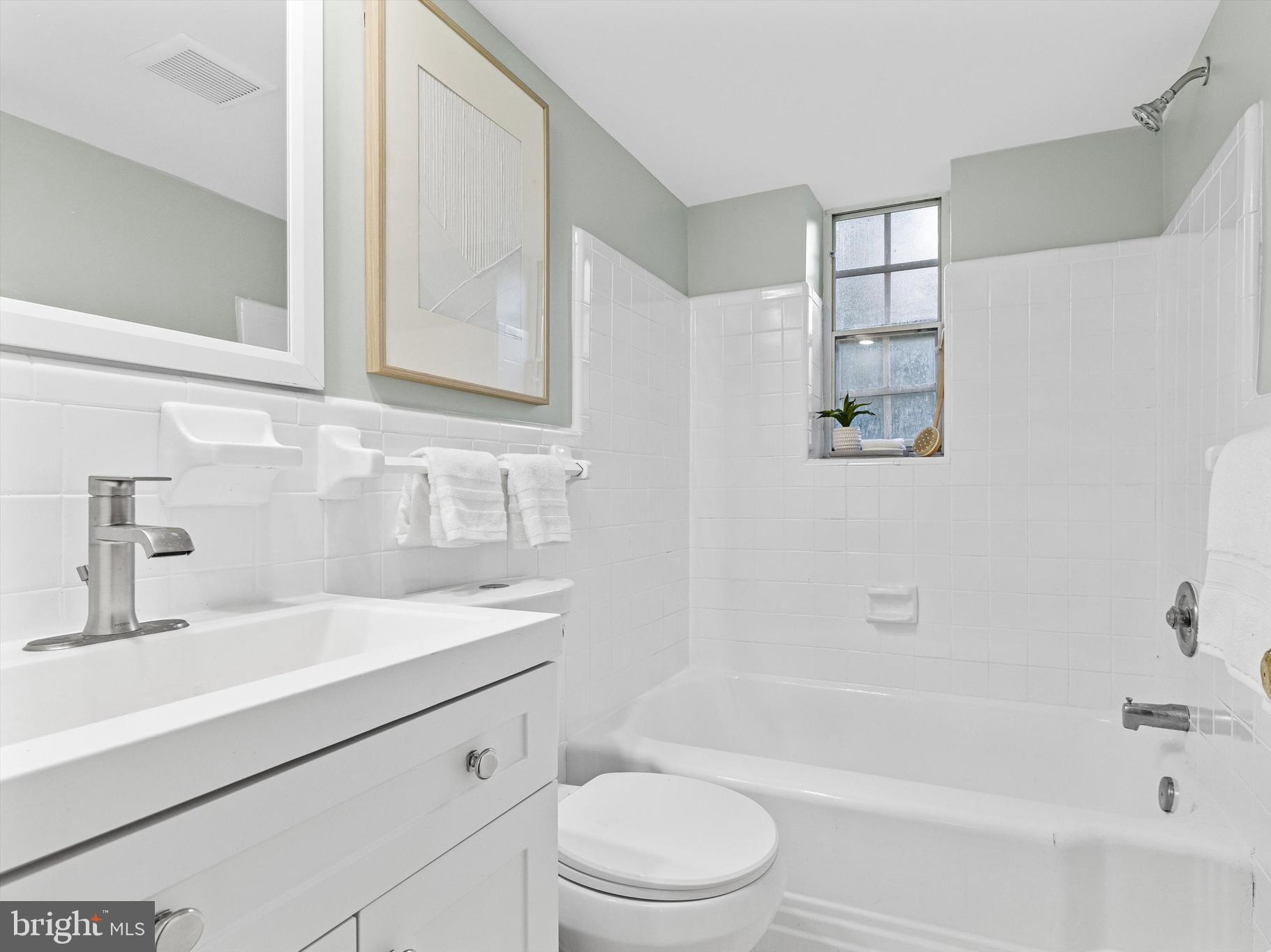 2107 North Scott Street, Unit 67 Arlington, VA 22209 - Photo 13 of 15 Bathroom with new vanity, toilet, mirror and light