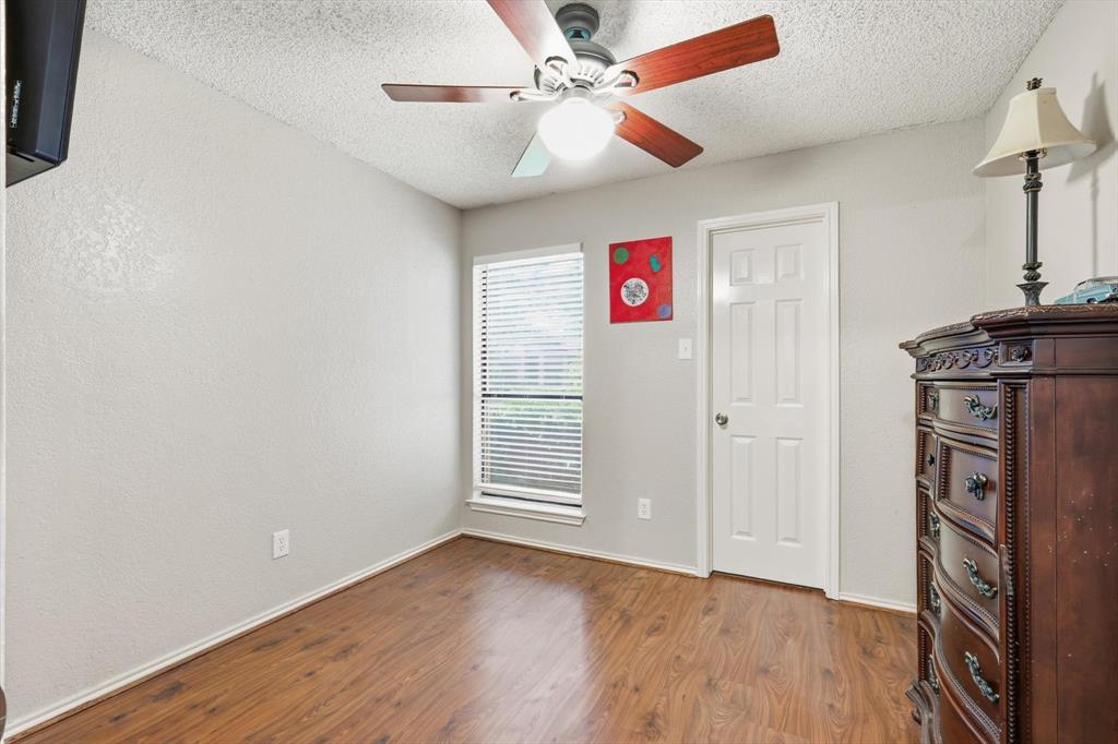 1312 Hackamore Street Mesquite, TX 75149 - Photo 18 of 23 Unfurnished bedroom with wood finished floors, ceiling fan, and a textured ceiling