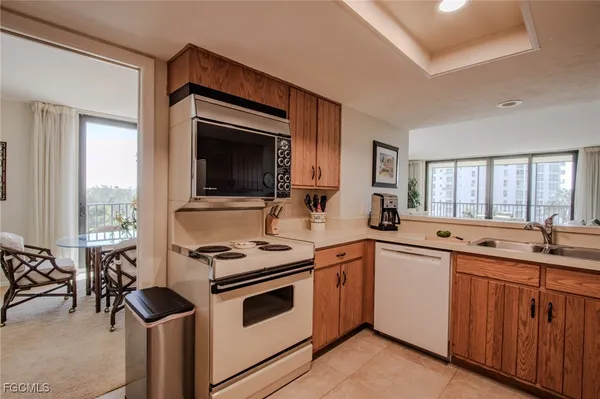 a kitchen with sink cabinets and white appliances