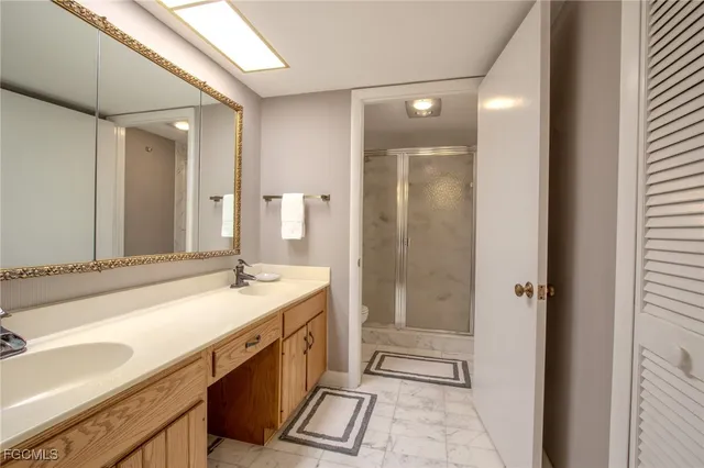 a spacious bathroom with a shower sink and mirror