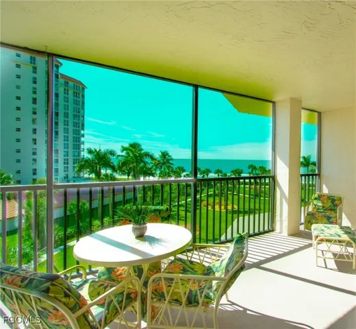 a view of a balcony with lake view and a potted plant