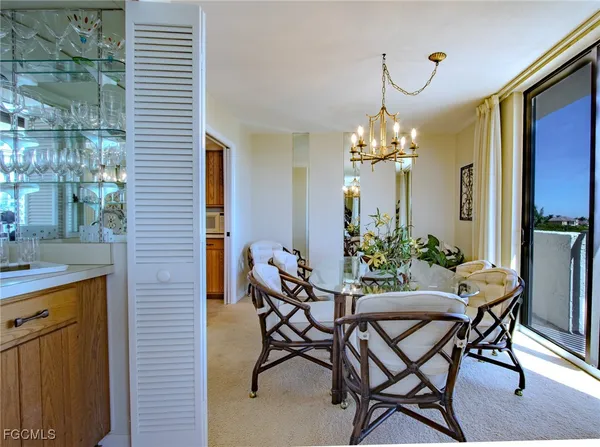 a view of a dining room with furniture and chandelier