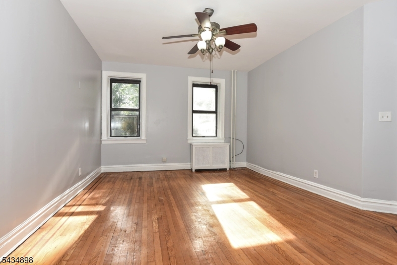 303 Hamilton Place, Unit A4 Hackensack, NJ 07601 - Photo 6 of 13 wooden floor in an empty room with a window
