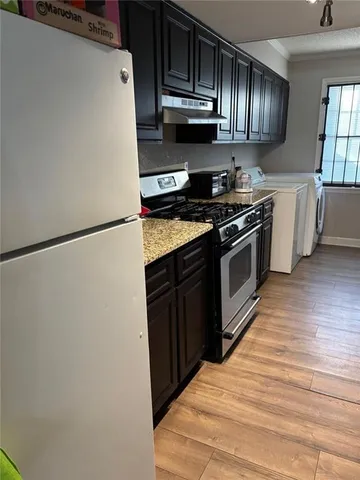 a kitchen with granite countertop cabinets and steel stainless steel appliances