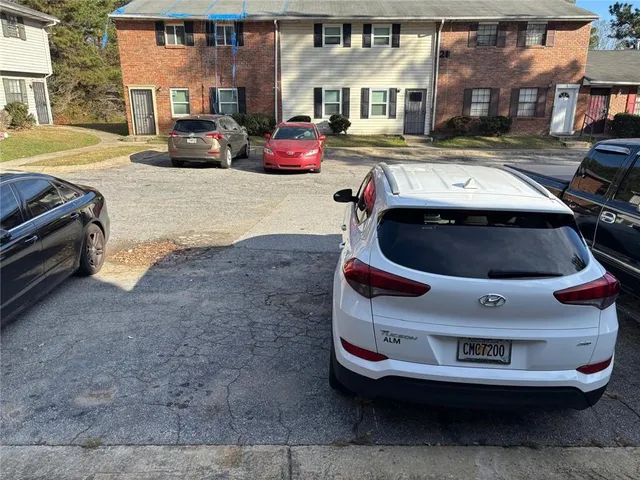 a view of a car parked in the street