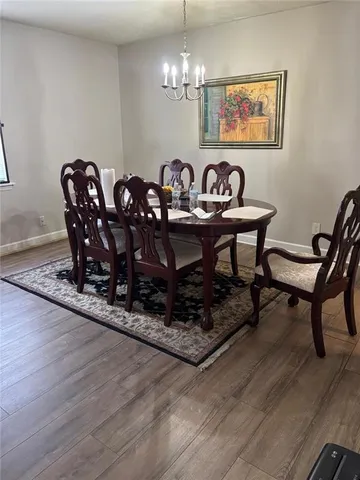a view of a dining room with furniture wooden floor and chandelier
