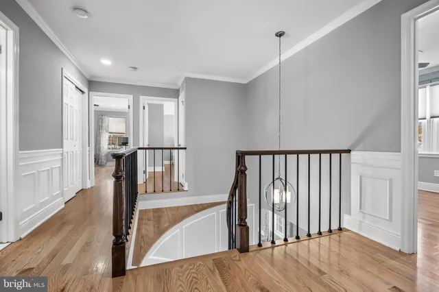 a view of a hallway with wooden floor and entryway