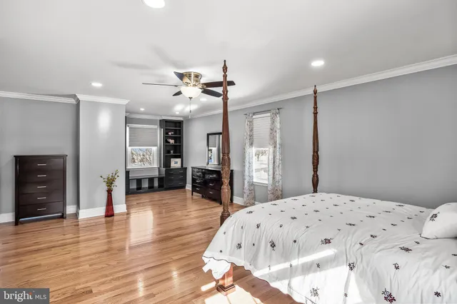 a large bedroom with a bed and a view of kitchen