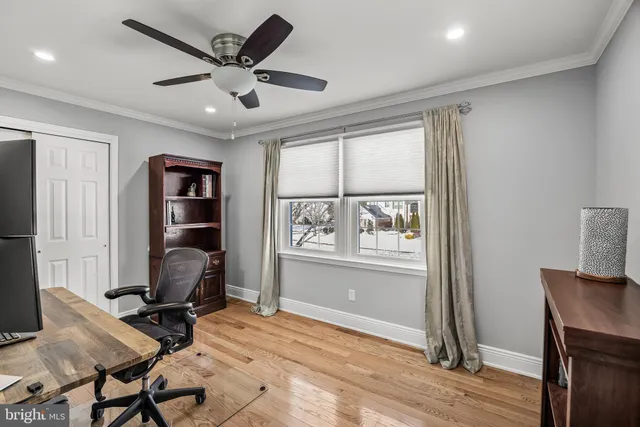 a view of a workspace with furniture and a window