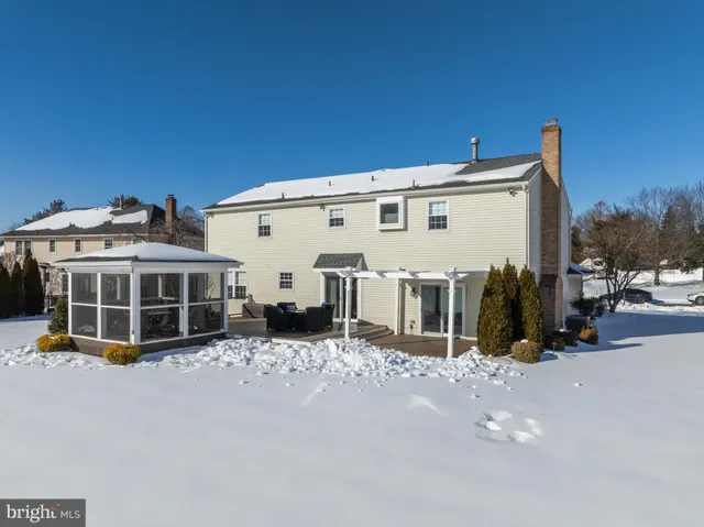 a view of a deck with couches floor to ceiling window next to a yard