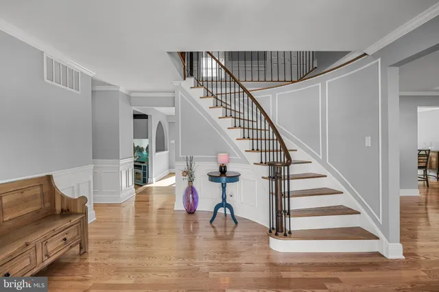 a view of entryway and hall with wooden floor