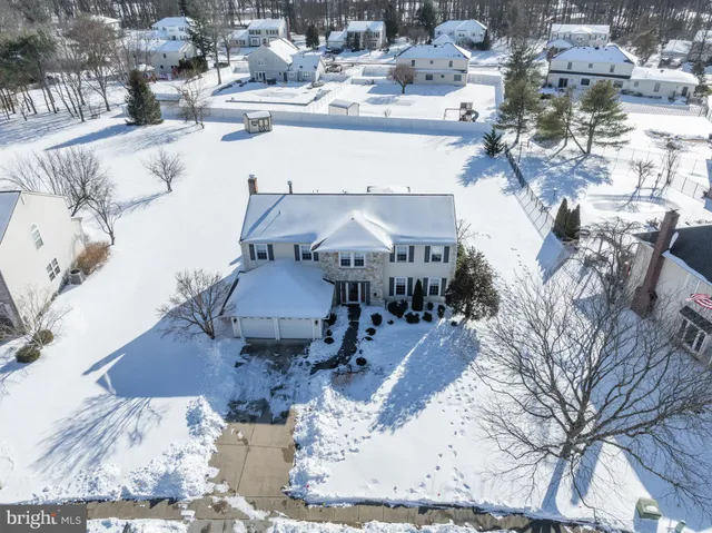an aerial view of a residential building with parking area