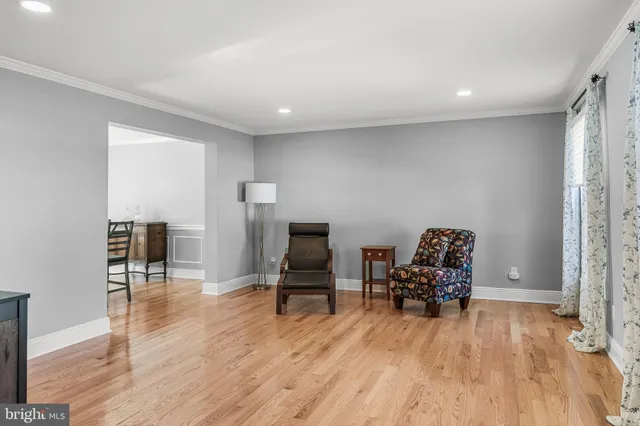a view of a workspace with furniture and wooden floor
