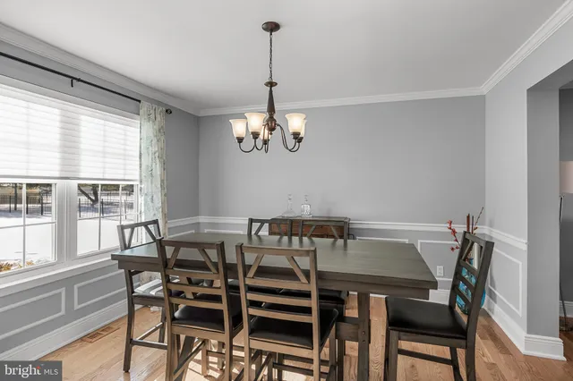 a view of a dining room with furniture wooden floor and a chandelier