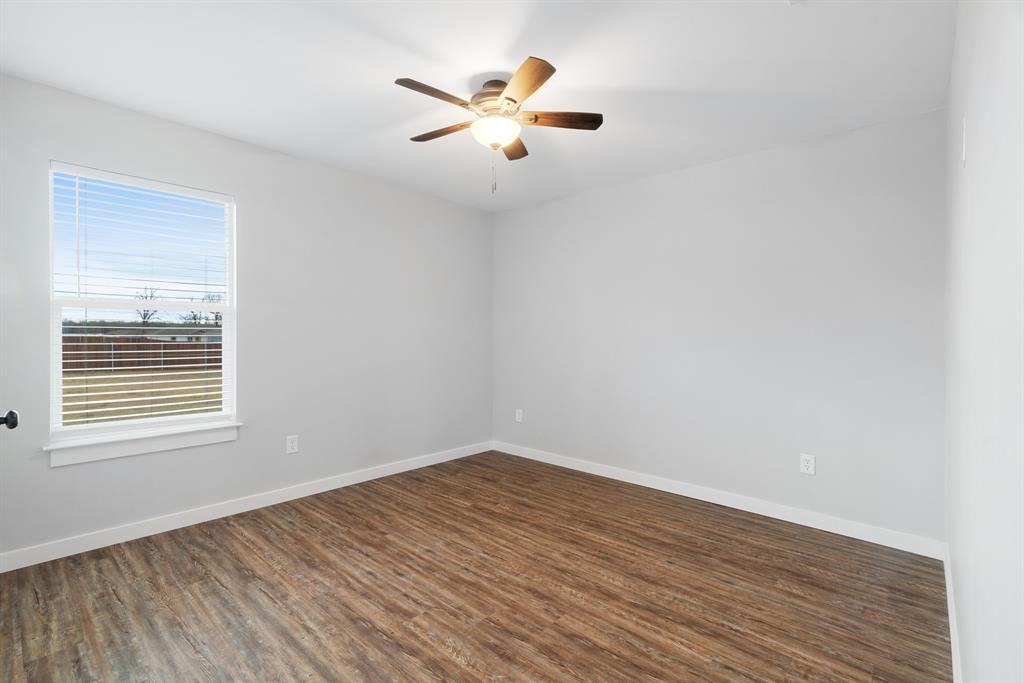 19 Private Road Paris, TX 75460 - Photo 17 of 18 wooden floor in an empty room with a window