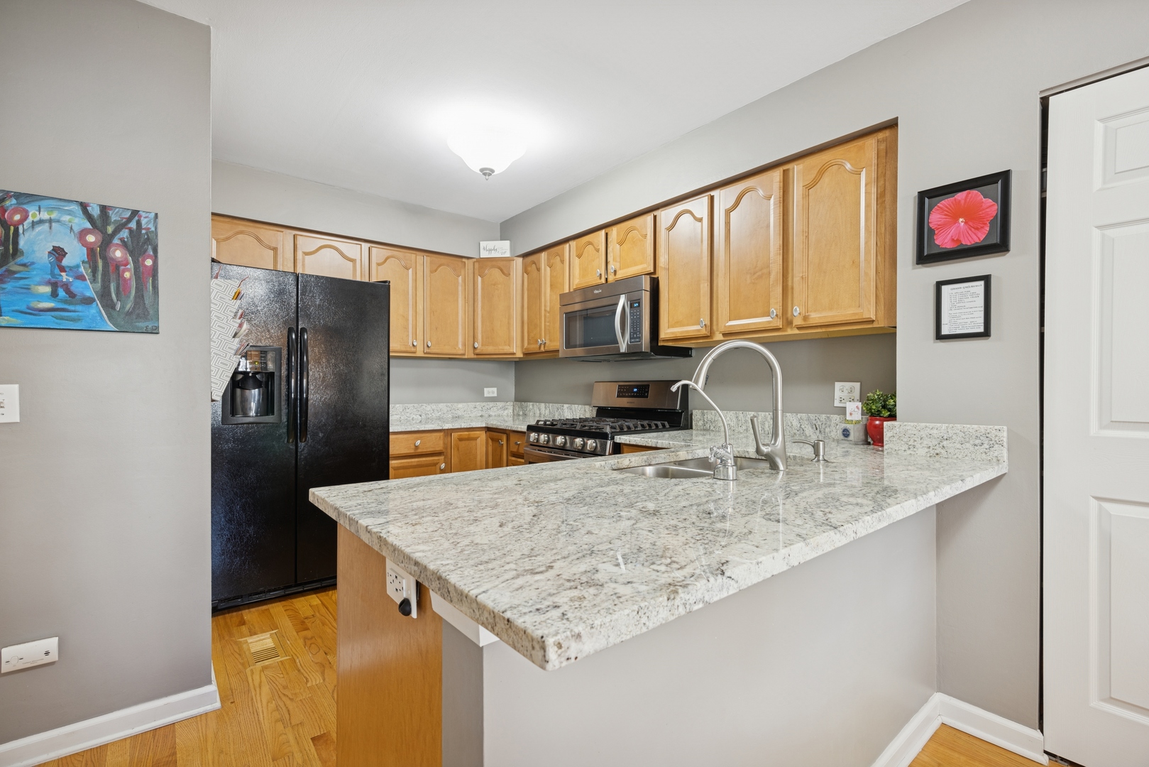 2618 Smith Street Rolling Meadows, IL 60008 - Photo 7 of 27 a kitchen with granite countertop a refrigerator a stove and a sink