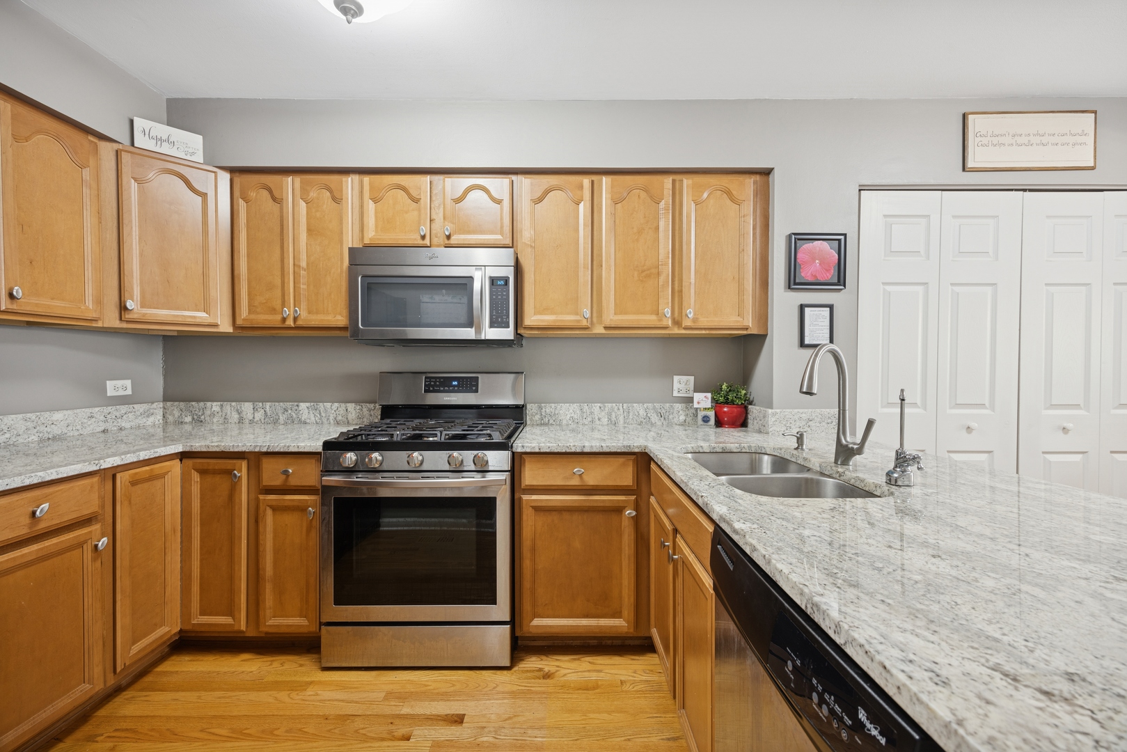 2618 Smith Street Rolling Meadows, IL 60008 - Photo 8 of 27 a kitchen with stainless steel appliances granite countertop a stove a sink and a microwave