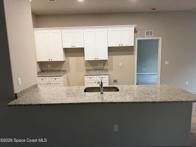 a kitchen with stainless steel appliances granite countertop a sink a stove and a refrigerator