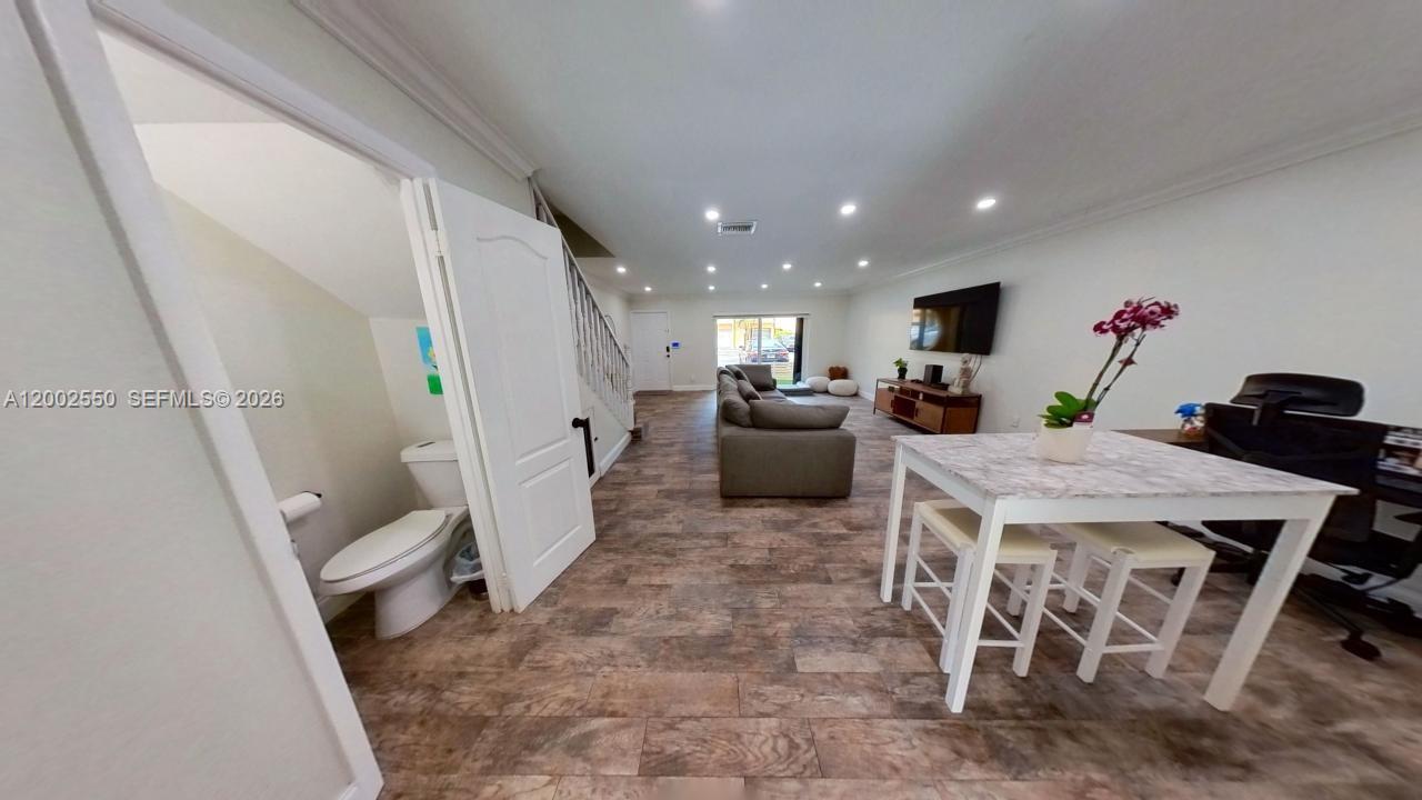 13731 Southwest 84th Street, Unit C11 Miami, FL 33143 - Photo 18 of 32 a open kitchen with a table and chairs