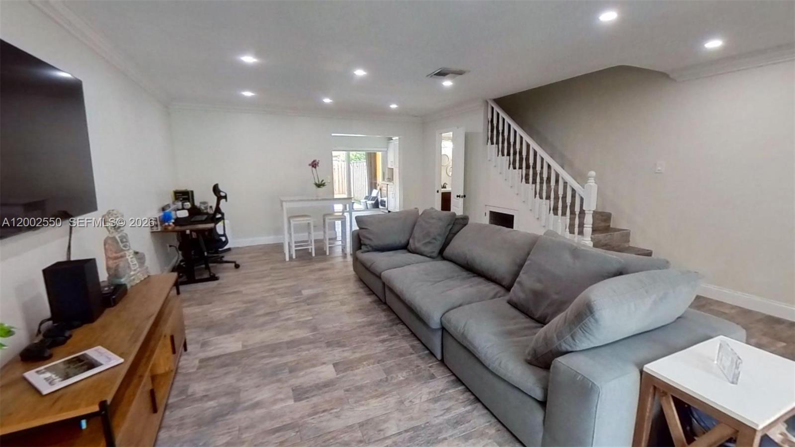 13731 Southwest 84th Street, Unit C11 Miami, FL 33143 - Photo 21 of 32 a living room with furniture and a flat screen tv