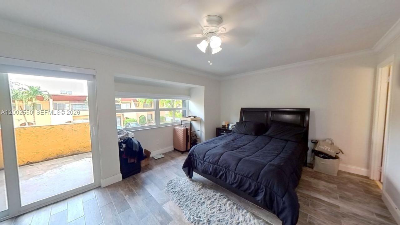 13731 Southwest 84th Street, Unit C11 Miami, FL 33143 - Photo 24 of 32 a bedroom with a large bed and a window