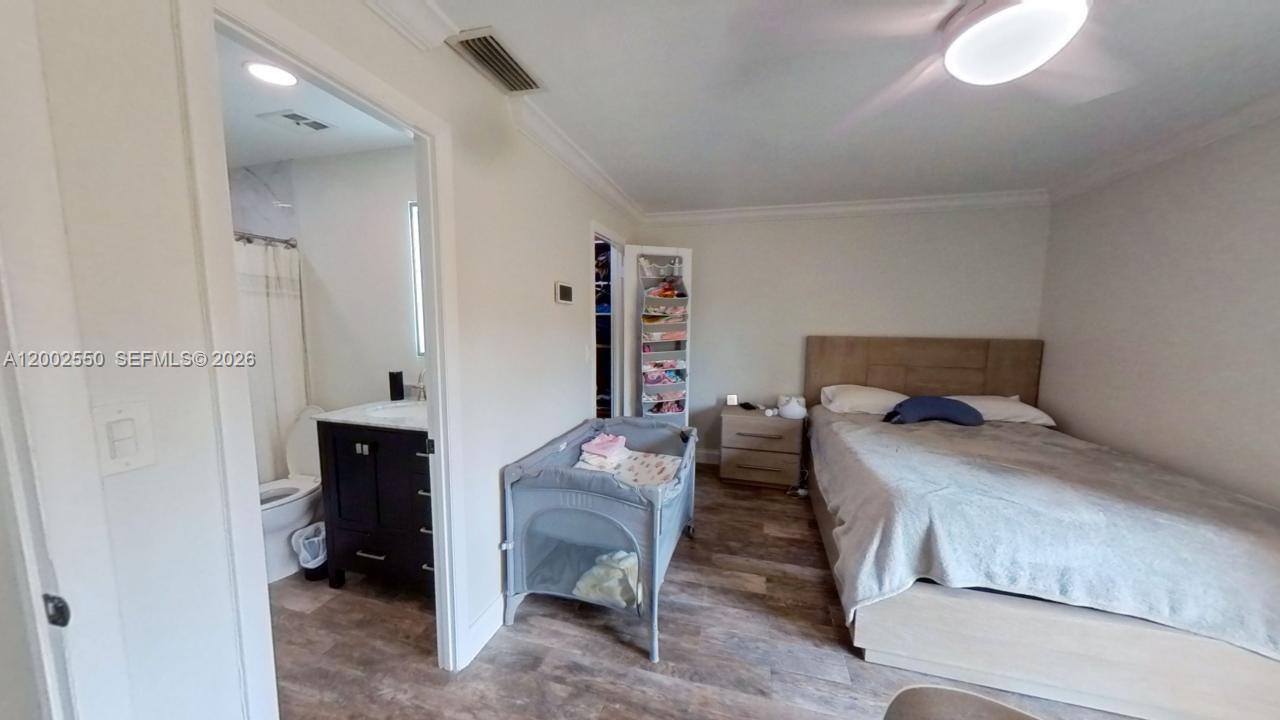 13731 Southwest 84th Street, Unit C11 Miami, FL 33143 - Photo 30 of 32 a bedroom with a bed and a table in it