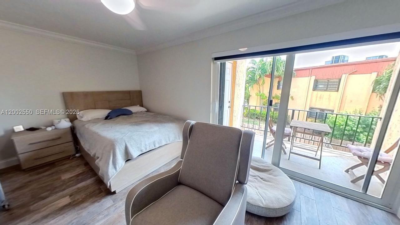 13731 Southwest 84th Street, Unit C11 Miami, FL 33143 - Photo 32 of 32 a bedroom with a bed and a large window