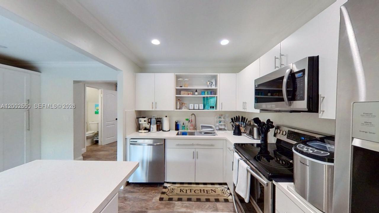 13731 Southwest 84th Street, Unit C11 Miami, FL 33143 - Photo 7 of 32 a kitchen with a sink appliances and cabinets