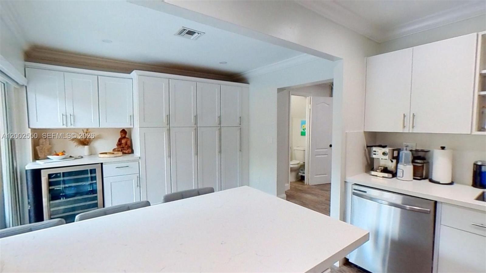 13731 Southwest 84th Street, Unit C11 Miami, FL 33143 - Photo 8 of 32 a kitchen with a refrigerator and white cabinets