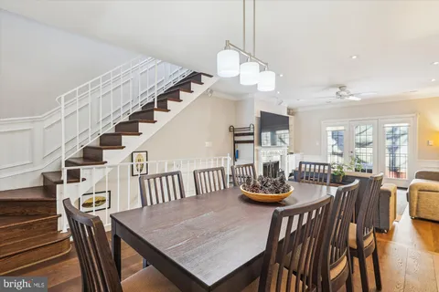a view of a dining room and livingroom with furniture wooden floor and a chandelier